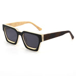 Sunglasses with black and gold frame on a white background, featuring the Caterside brand.