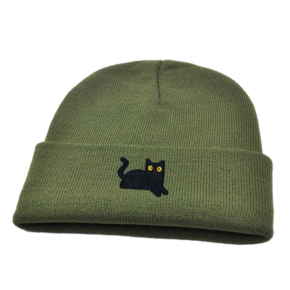 Green beanie with a black cat embroidery on a white background