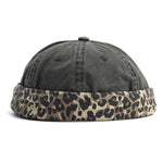 Army green cap with a leopard print band on a white background