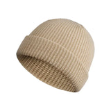 Beige knit beanie on a white background