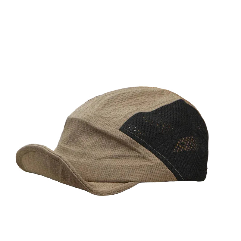 Beige cap with black mesh panel on an open book
