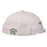 Beige cap with a 'Brooklyn New York' patch on a white background