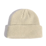 Beige knit beanie on a white background