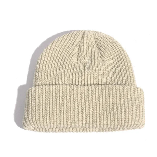 Beige knit beanie on a white background
