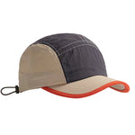 Two-toned cap with dark blue and beige sections on a beige background