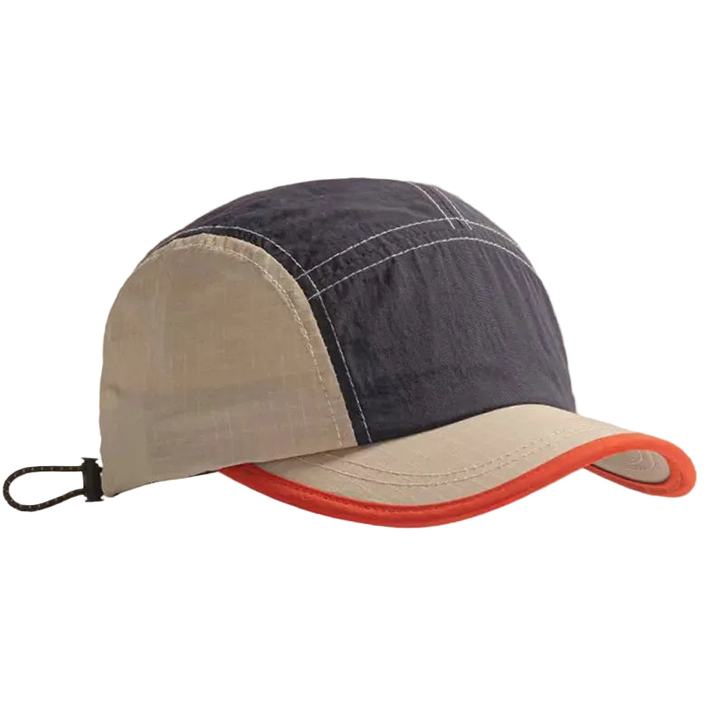 Two-toned cap with dark blue and beige sections on a beige background