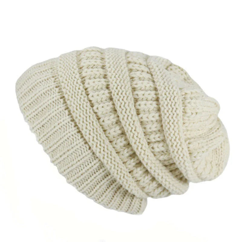 Knitted beige beanie on a white background