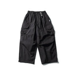 Black 2 Parachute cargo pants flat lay showing drawstring waist and layered pocket design