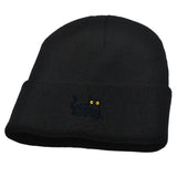 Black beanie with a small embroidered design on a white background