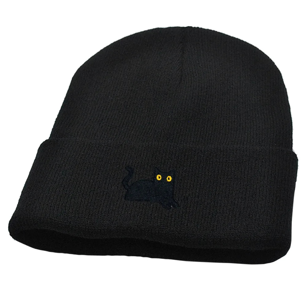 Black beanie with a small embroidered design on a white background