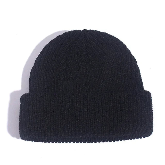 Black knit beanie on a white background