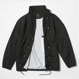 Black Nylon coach jacket laid flat open showing snap buttons and white lining