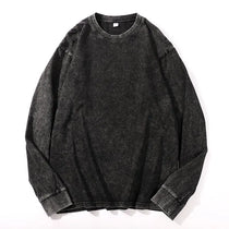 Black denim shirt with rolled-up sleeves on a white background