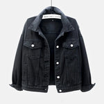 Black Close-up on-model detail of blue oversized denim jacket showing collar and button closure