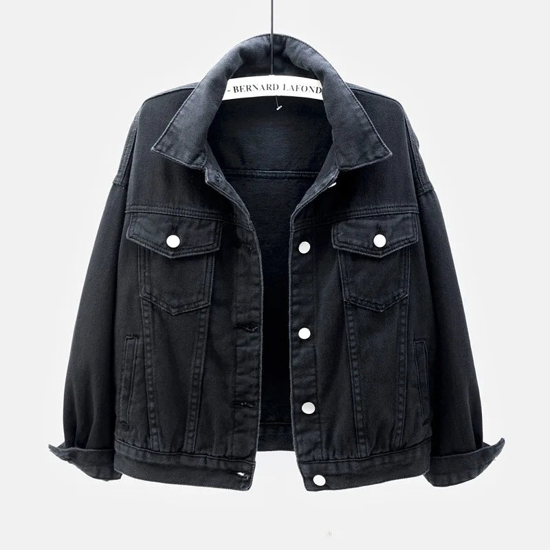 Black Close-up on-model detail of blue oversized denim jacket showing collar and button closure
