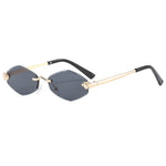 Sunglasses with gold frame and black arms on a white background
