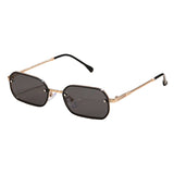 Sunglasses with gold frame and black lenses on a light beige background