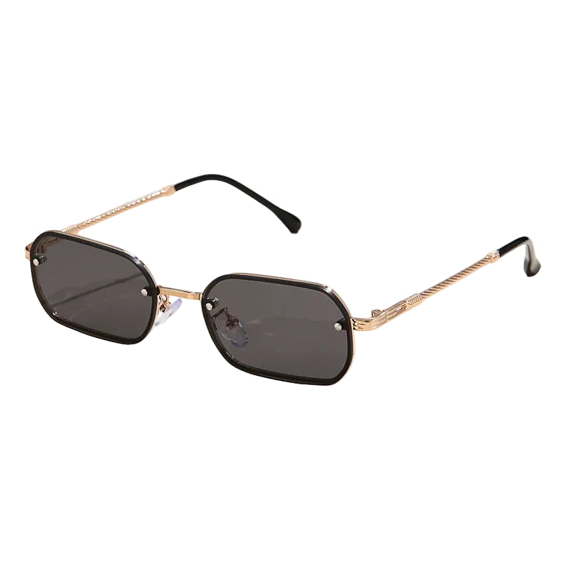Sunglasses with gold frame and black lenses on a light beige background