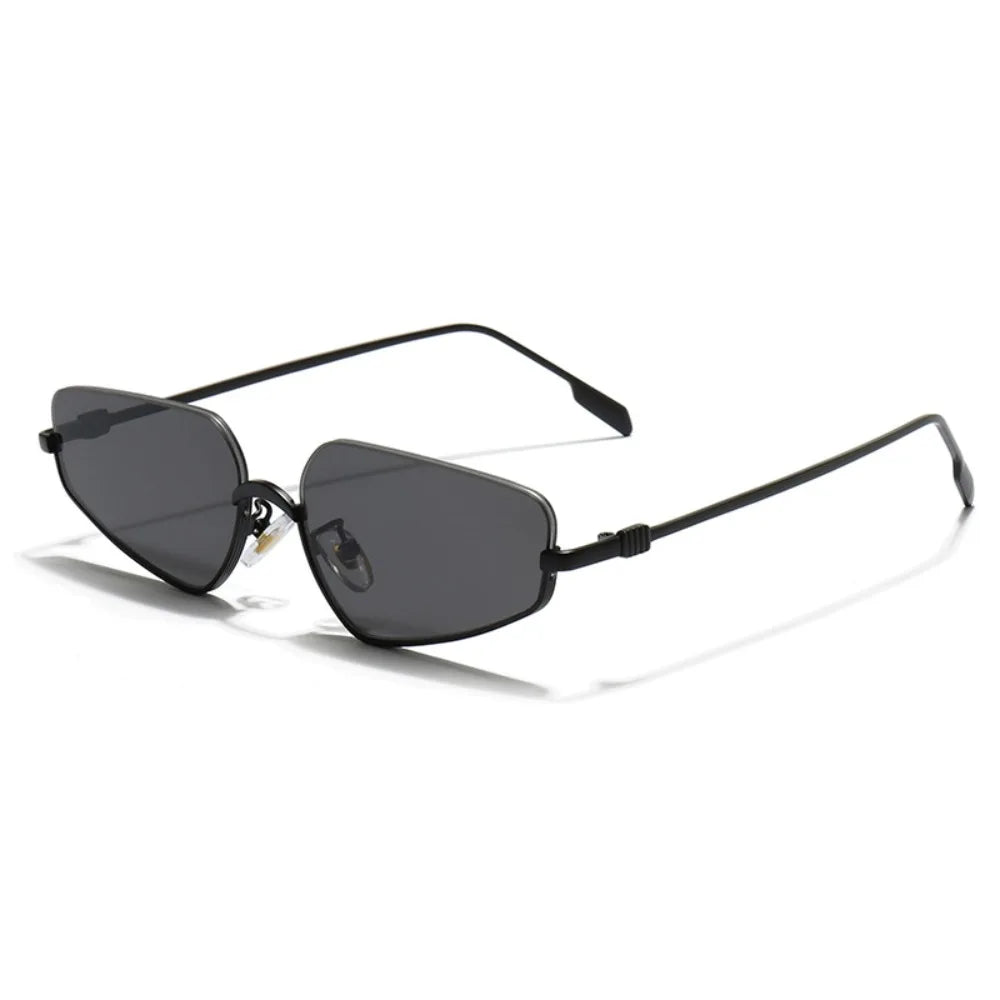 Gold-framed sunglasses with black lenses on a light gray background
