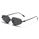 Gold-framed sunglasses with black lenses on a light gray background
