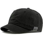 Black Short brim baseball cap worn on model — side