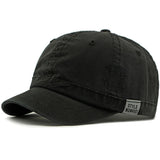 Black Short brim baseball cap worn on model — side