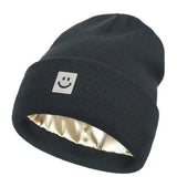 Black beanie with a smiley face logo on a white background