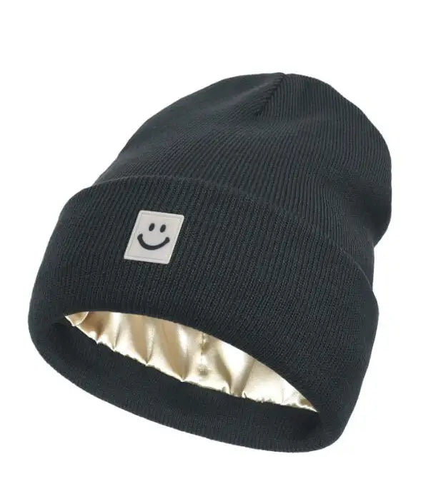 Black beanie with a smiley face logo on a white background