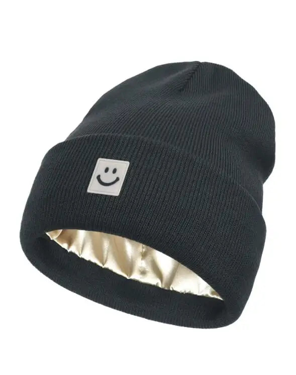 Black beanie with a smiley face logo on a white background