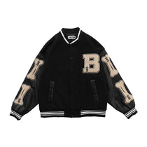 Black Streetwear college jacket flat lay showing bone patch embroidery and leather sleeves