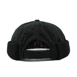 Black knit beanie with textured pattern on a white background