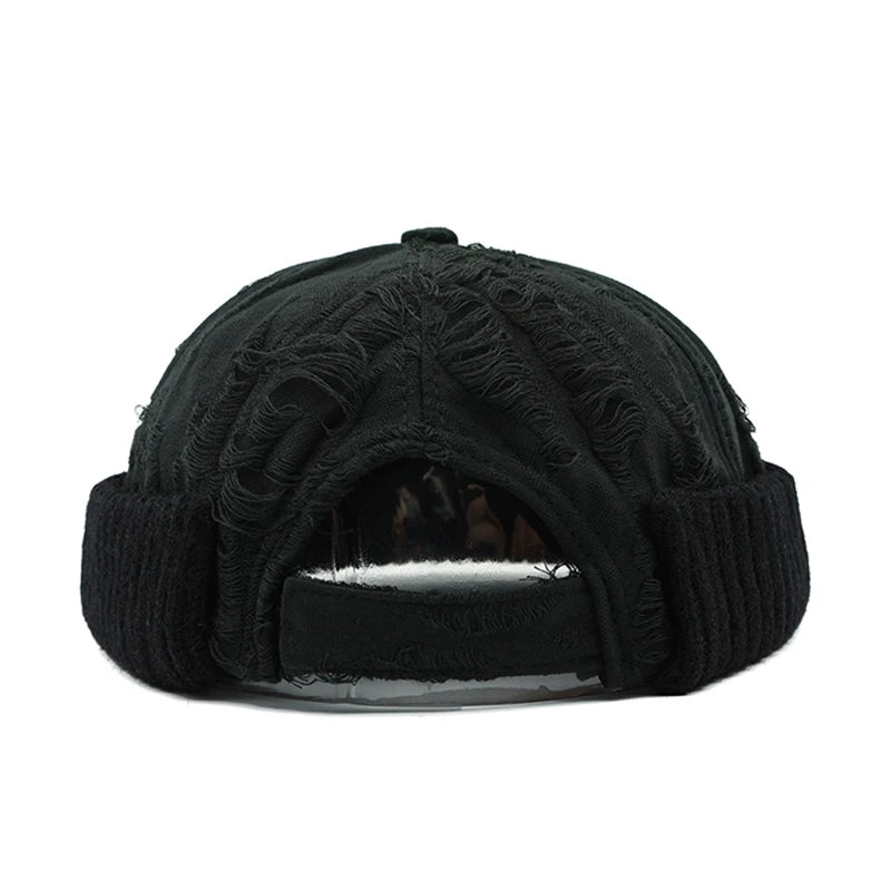 Black knit beanie with textured pattern on a white background