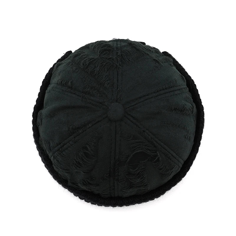 Black textured round pillow on a white background