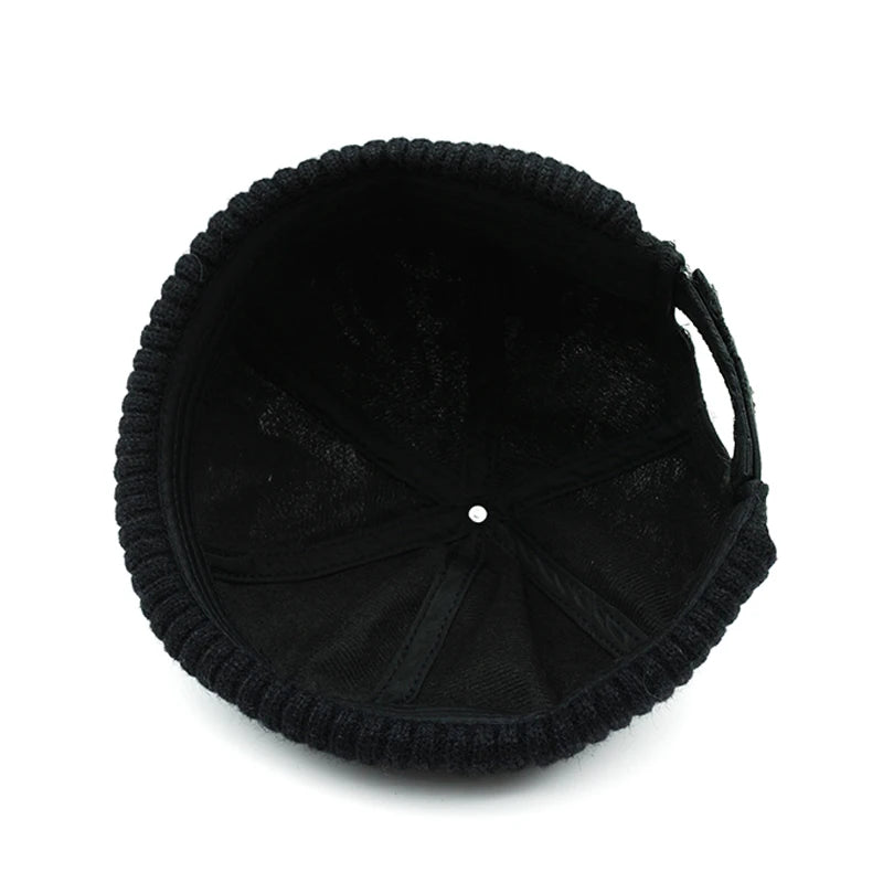 Black knit beanie on a white background