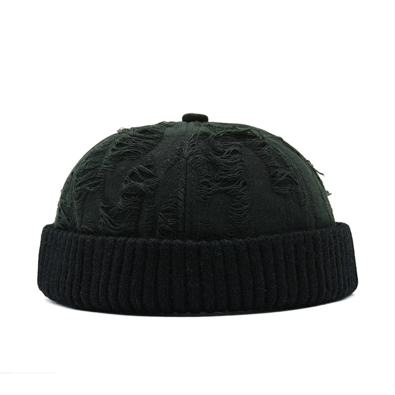 Black knit beanie with textured pattern on a white background