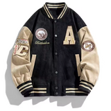 Black varsity jacket with beige sleeves and multiple patches on a white background