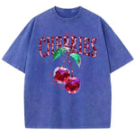 Blue 3 Graphic tee flat lay showing cherries print with leopard lettering on washed cotton