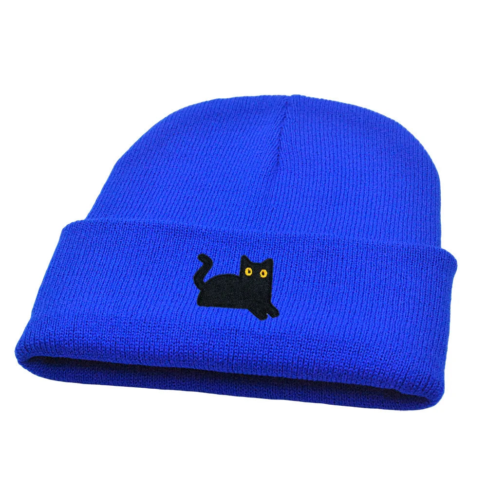 Blue beanie with a black cat embroidery on a white background