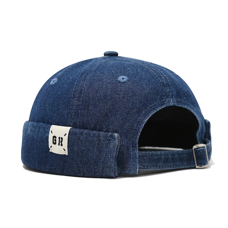 Blue denim cap with a brand logo on the side panel against a white background