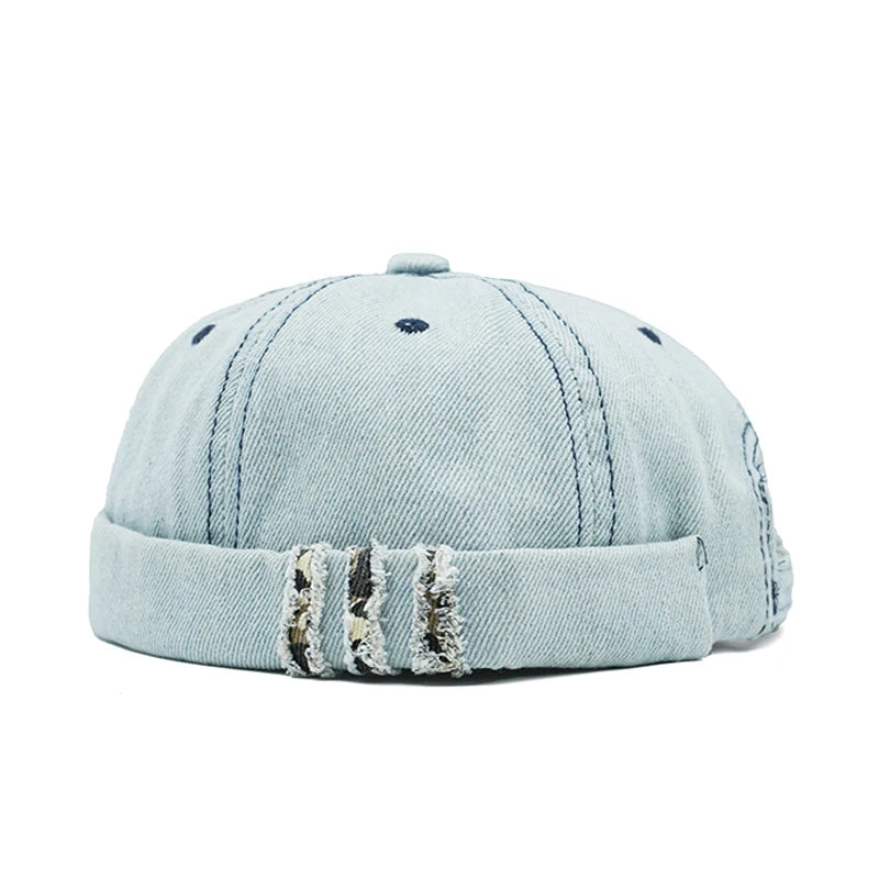 Light blue denim cap with distressed details on a white background