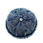 Blue denim cap with a button on a white background