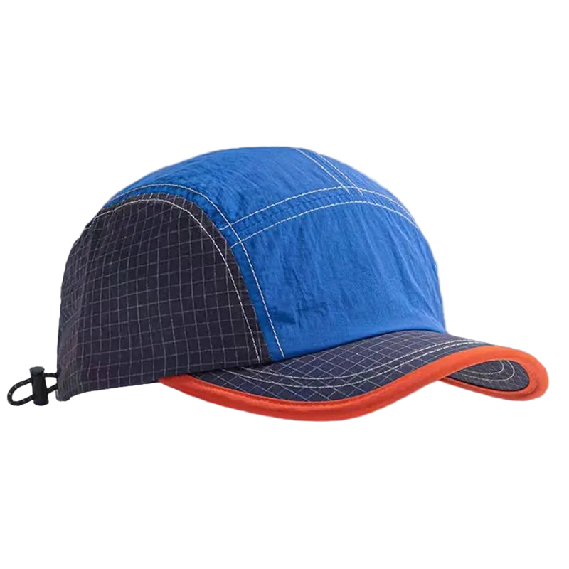Blue cap with black grid pattern and orange rim on a gray background