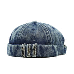 Blue denim cap with distressed details on a white background