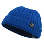 Blue knit beanie with a smiley face logo on a white background
