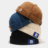 Brimless corduroy docker cap worn on model, front view