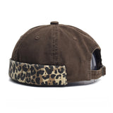 Brown cap with leopard print band on a white background