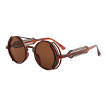 Round sunglasses with brown lenses and red and gold frames on a white background