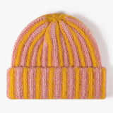 Knitted beanie with pink and yellow stripes on a white background