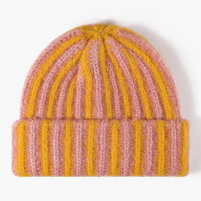 Knitted beanie with pink and yellow stripes on a white background