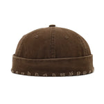 Brown beanie with embroidered patterns on a white background
